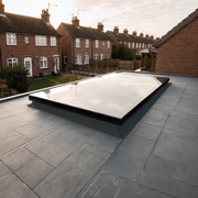 Installed rooflight on a residential property with houses in the background